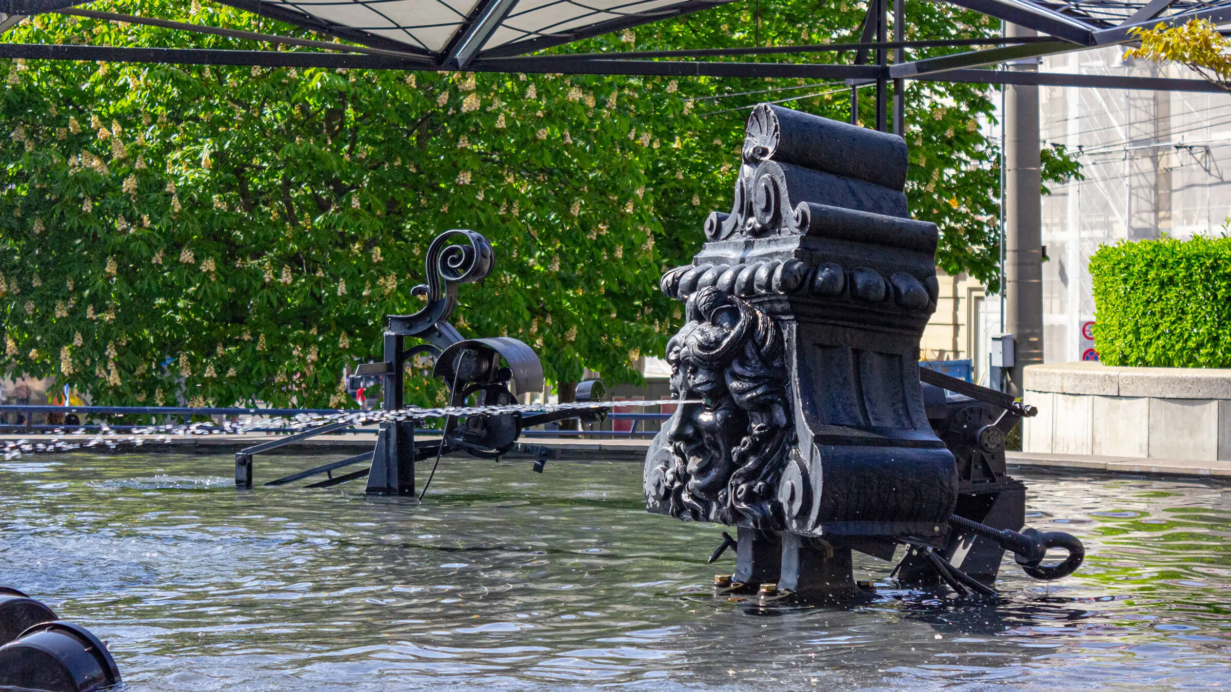 Metallic lion sculpture in the water