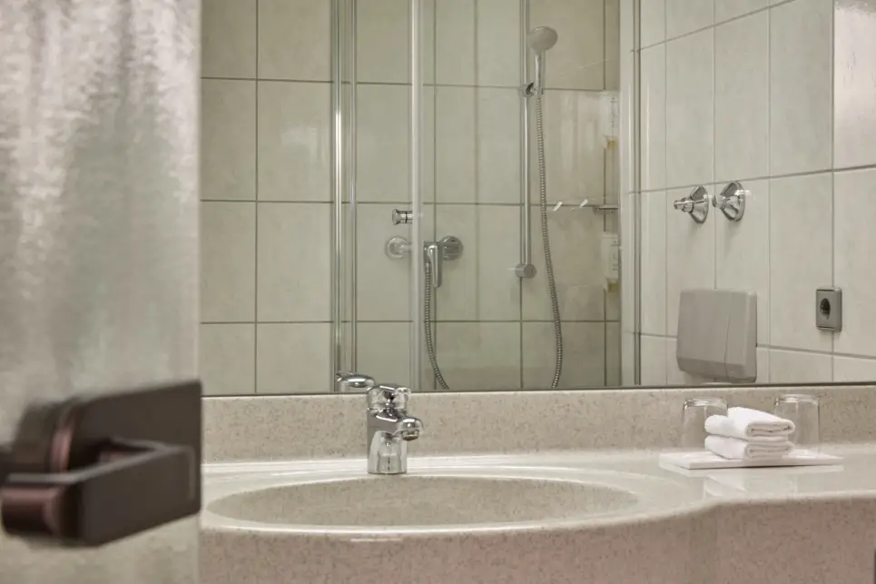 Il bagno della camera Comfort con letti separati all'H+ Hotel Stuttgart Herrenberg