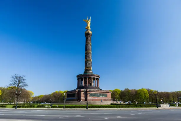 Siegessäule am Tag. Im Vordergrund ist eine Straße.