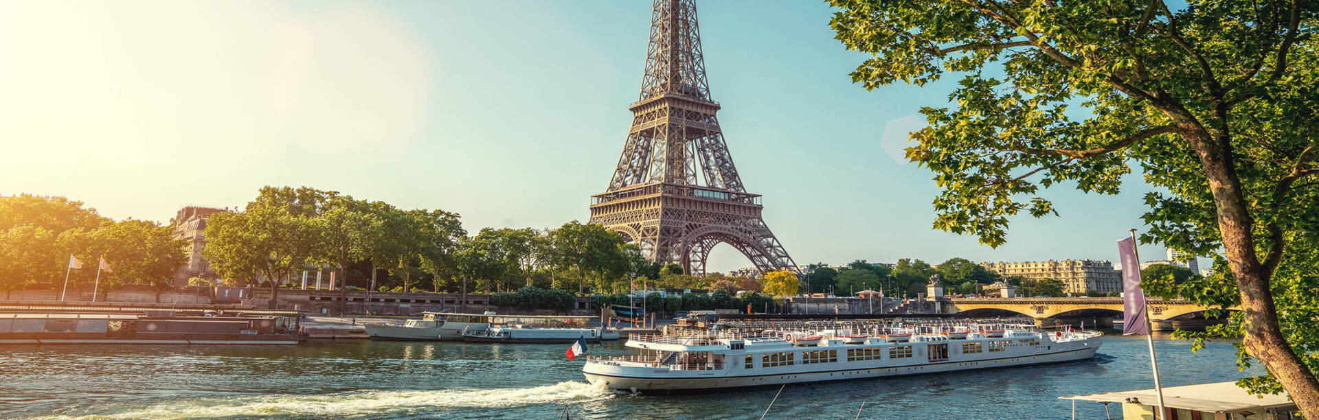 View across the Seine to the Eiffel Tower. A ferry sails on the Seine.