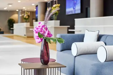 Lobby area at the hotel reception. There is a vase of flowers on the table.